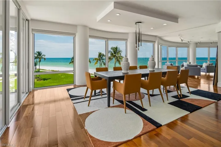 Dining area featuring track lighting, hardwood / wood-style floors, and a water view