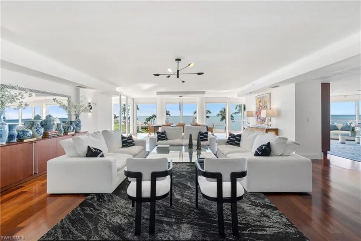 Living room featuring a chandelier and dark wood-style floors