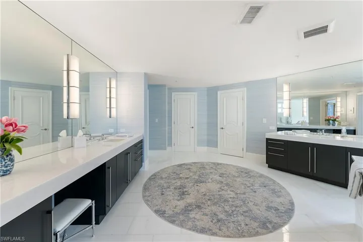 Full bathroom featuring two vanities