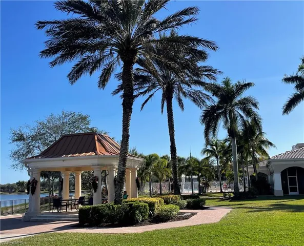 View of property's community with a gazebo, a yard, and a water view