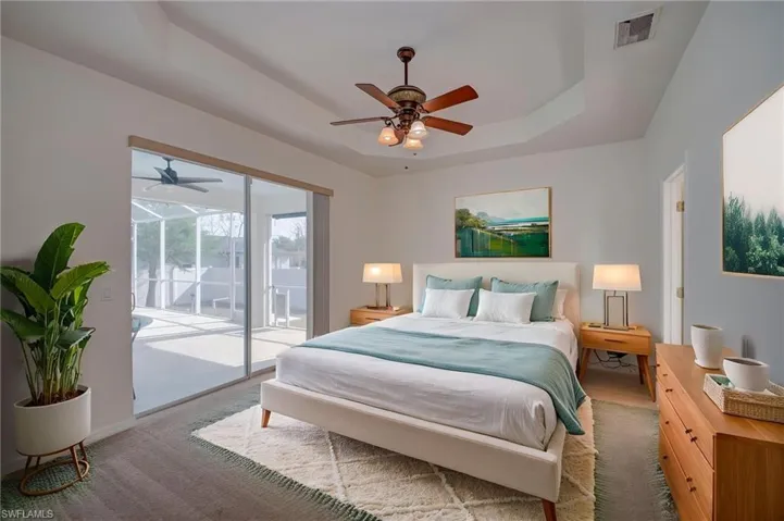 Primary suite virtually staged with access to lanai