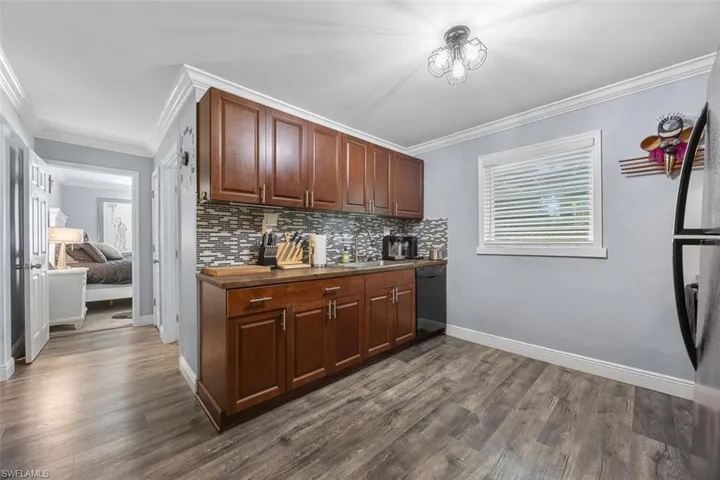 kitchen featuring backsplash and wood countertops