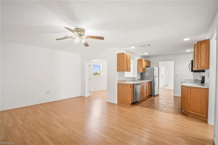 Kitchen with recessed lighting, light wood-style floors, appliances with stainless steel finishes, light countertops, and ceiling fan