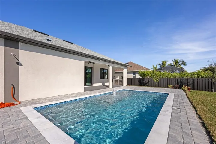 View of swimming pool featuring a patio, pool water feature, and ceiling fan