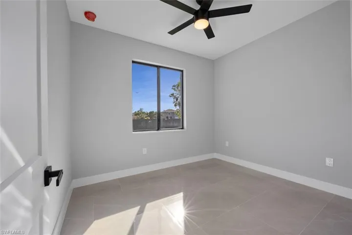 Spare room with ceiling fan and a raised ceiling