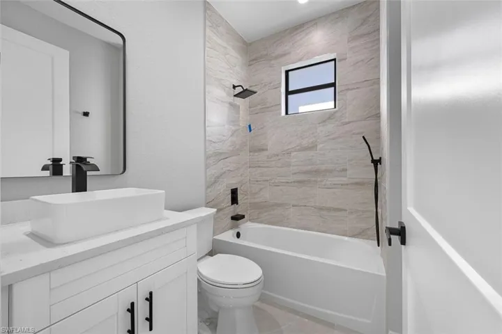 Unfurnished bedroom featuring light tile patterned floors, a closet, and ceiling fan