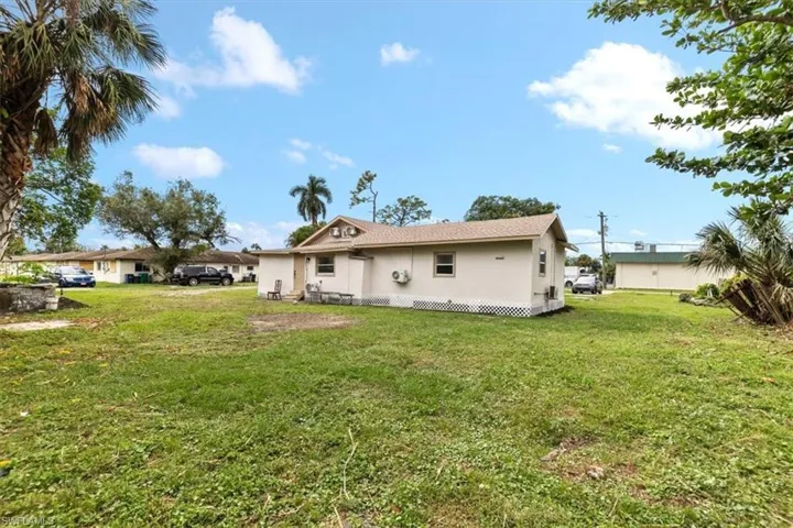 Back of house featuring a lawn