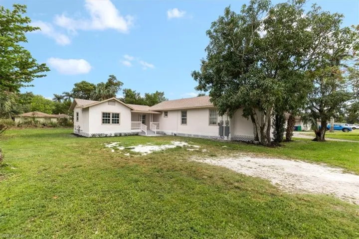 Back of property featuring a yard