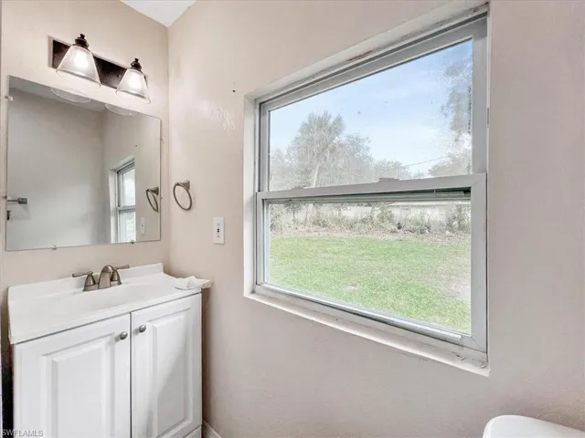 Bathroom with vanity and a healthy amount of sunlight