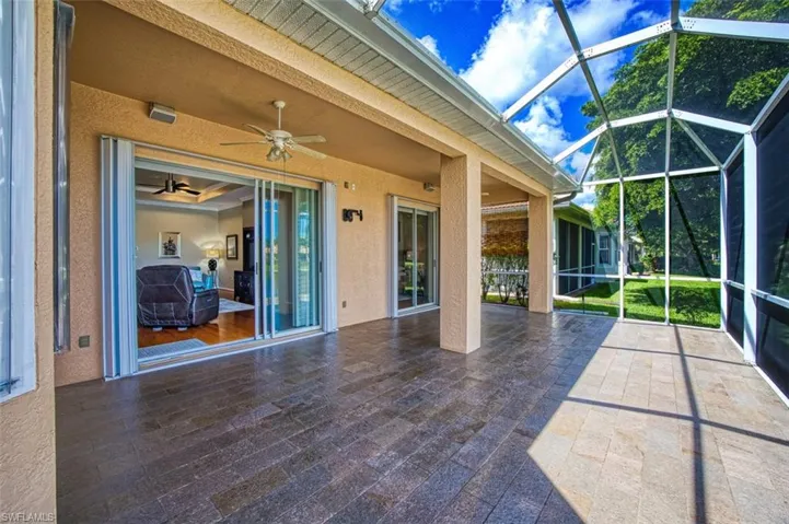 Unfurnished sunroom featuring ceiling fan