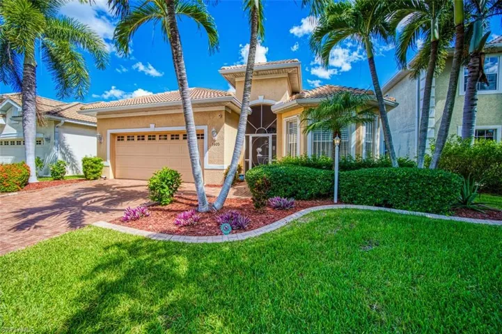 Mediterranean / spanish-style home with a front yard and a garage