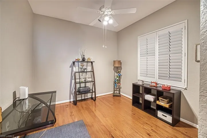 Misc room with ceiling fan and light wood-type flooring