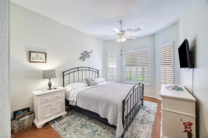 Bedroom with hardwood / wood-style flooring and ceiling fan