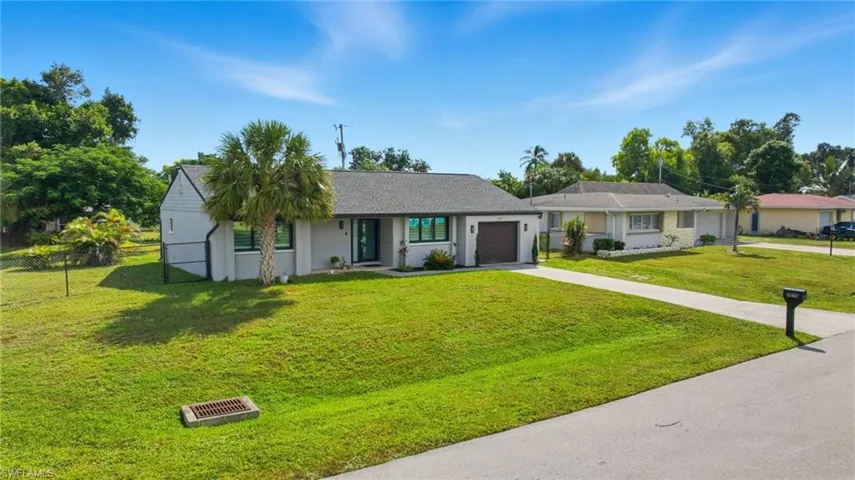 Ranch-style home featuring concrete driveway and a garage