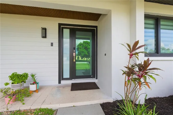 Entrance to property featuring stucco siding