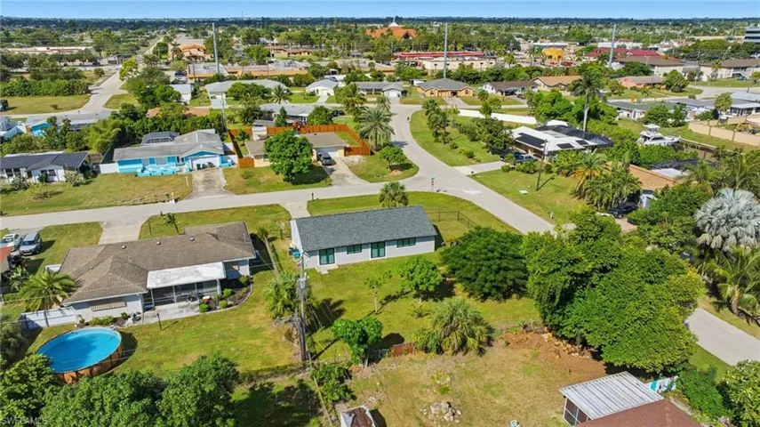 View of property location with a pool and nearby suburban area