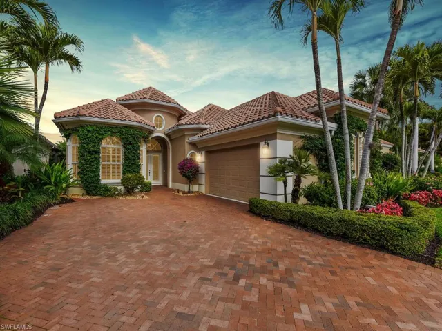 Mediterranean / spanish-style home with stucco siding, a tile roof, a garage, and decorative driveway