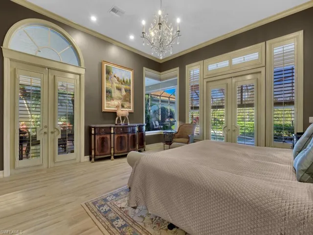 Primary Bedroom featuring French doors, access to outside, and suspended lighting.