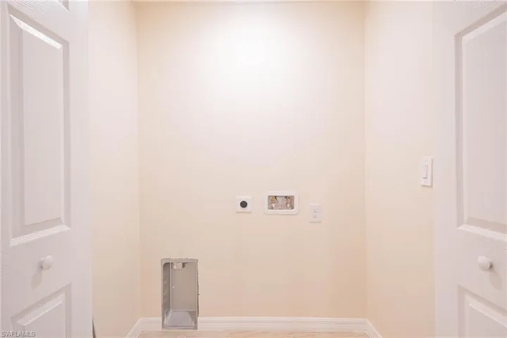 Laundry room featuring washer hookup, electric dryer hookup, and light wood-type flooring