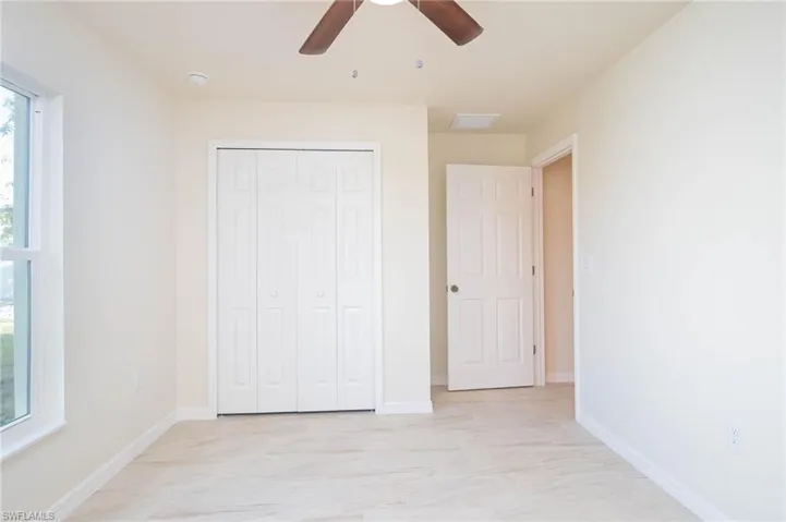 Unfurnished bedroom featuring ceiling fan and a closet
