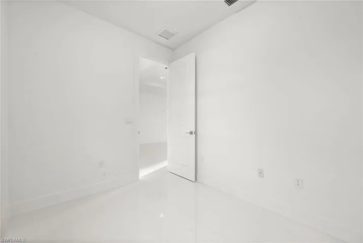 Empty room featuring baseboards