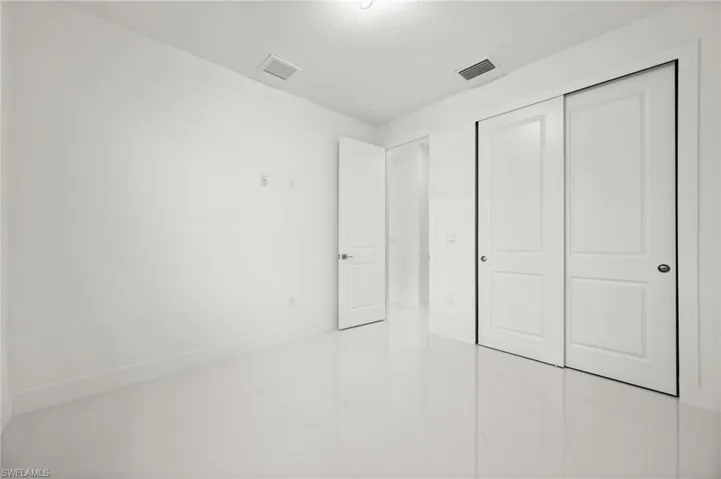 Unfurnished bedroom featuring a closet and baseboards