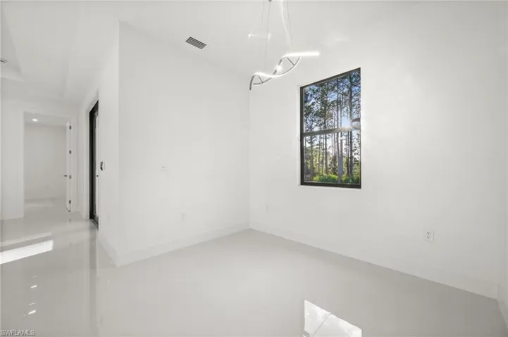 Unfurnished room featuring finished concrete flooring
