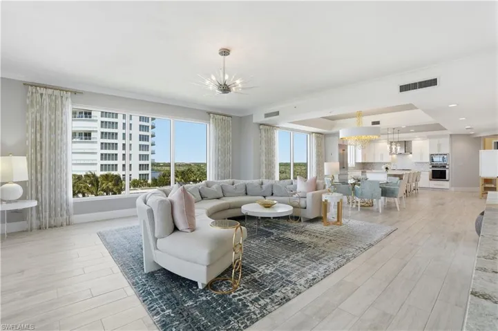 The large great room offers floor to ceiling windows with ample gathering space for friends and family.