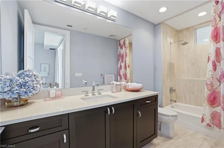 Ensuite guest bathroom with shower/tub combo.