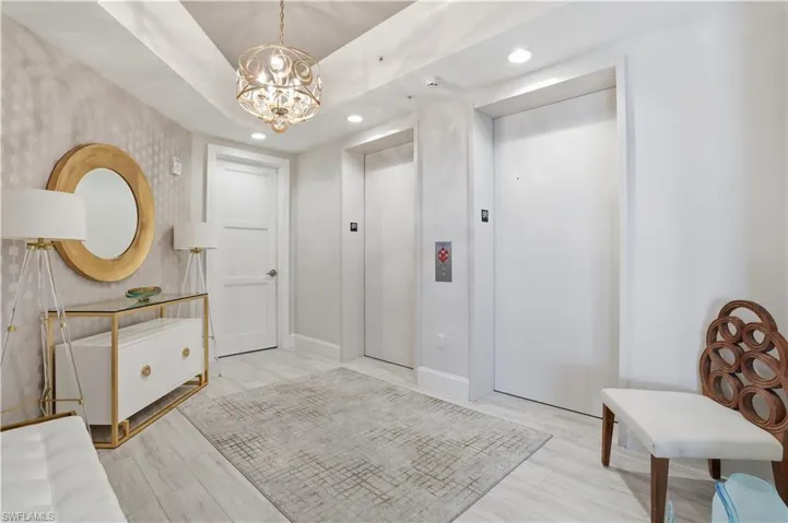 A stately entryway. Through the side door is the trash chute and stairway.