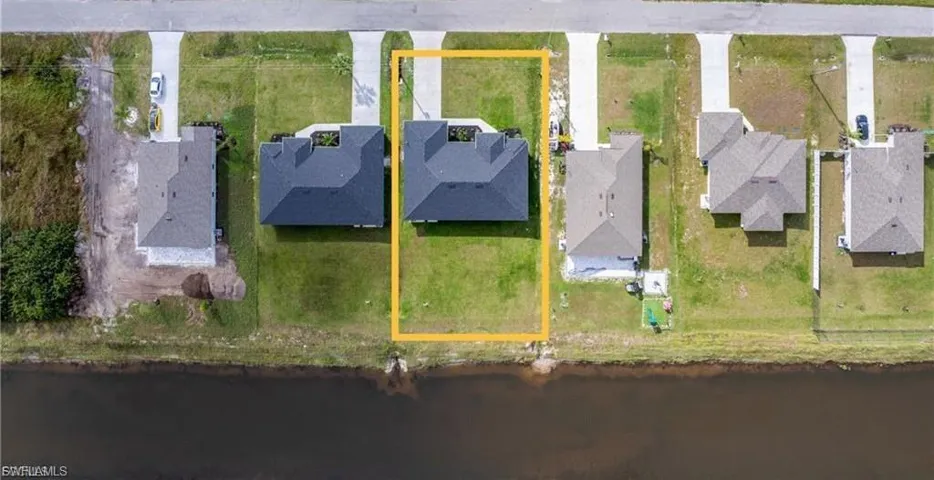 Aerial perspective of suburban area featuring a large body of water