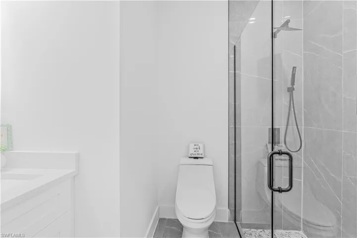 Bathroom with vanity and a stall shower