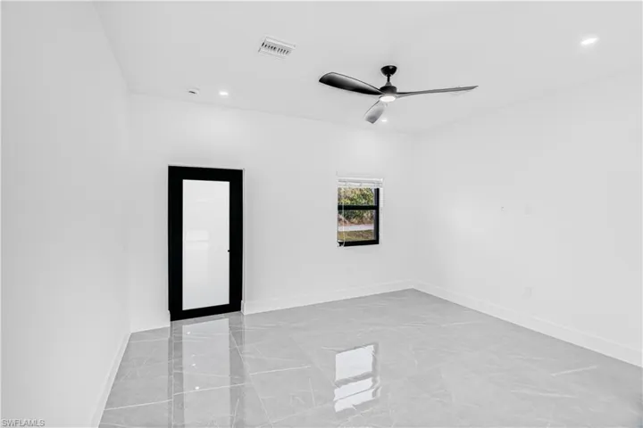 Spare room featuring recessed lighting, a ceiling fan, and light marble finish flooring