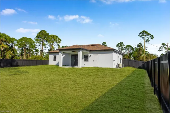 Back of property featuring a patio area, stucco siding, and a fenced backyard
