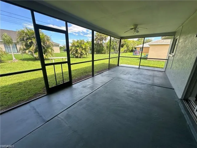 Unfurnished sunroom with ceiling fan