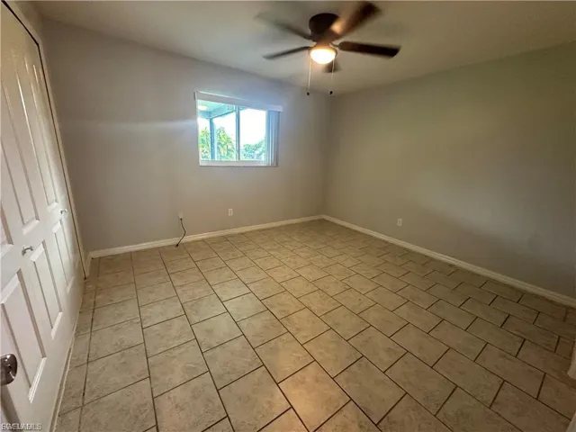 Spare room with light tile patterned floors and ceiling fan