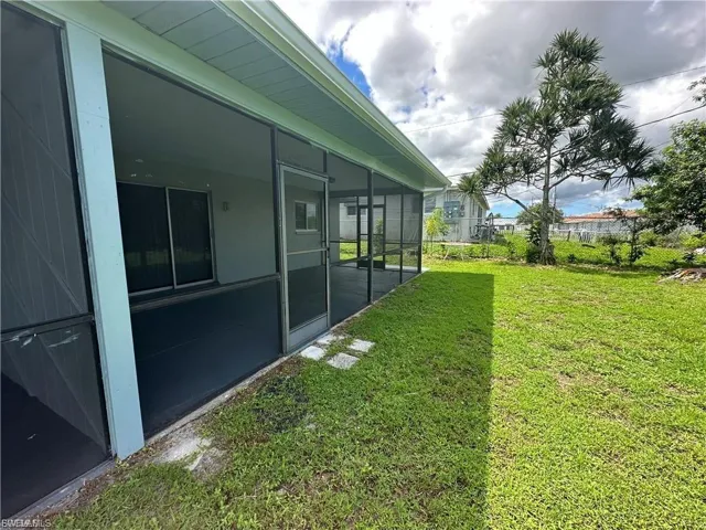View of yard featuring a sunroom