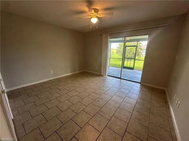 Spare room featuring light tile patterned flooring and ceiling fan