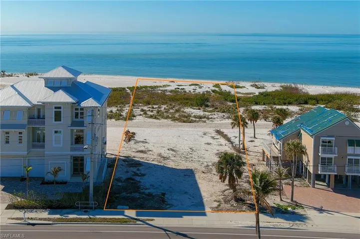 Drone / aerial view with a water view and a beach view