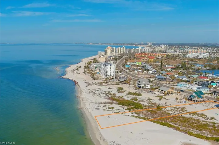 Aerial view featuring a water view and a view of the beach