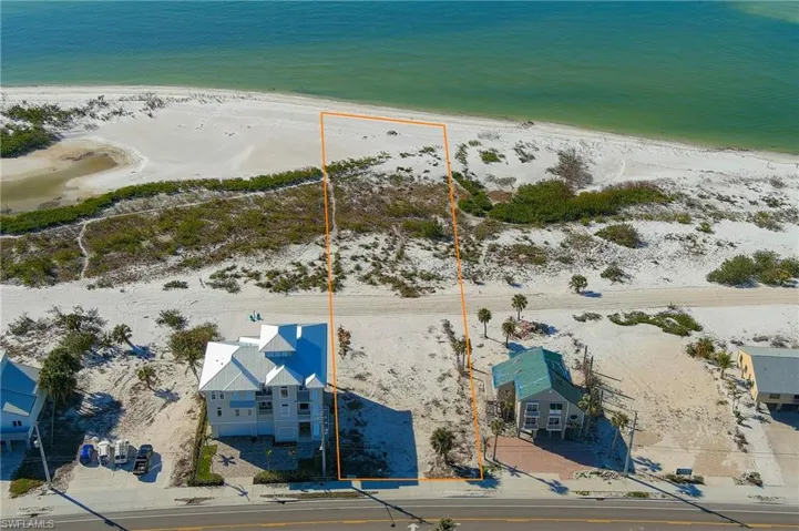 Bird's eye view featuring a water view and a beach view