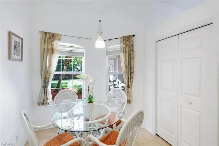 Dining space with light tile patterned floors