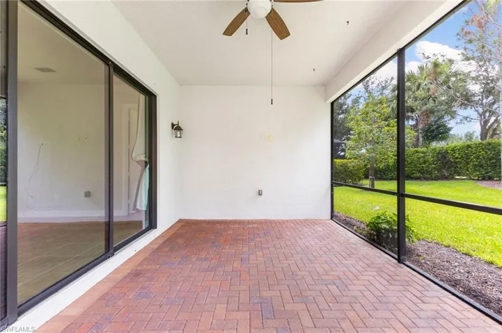 Unfurnished sunroom featuring ceiling fan