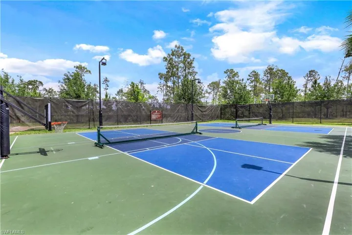 View of sport court featuring tennis court