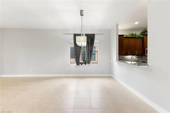 Unfurnished dining area with light tile patterned flooring