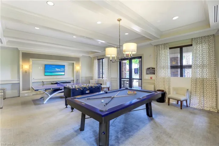 Rec room featuring beamed ceiling, crown molding, a wealth of natural light, and pool table