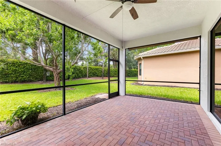 Unfurnished sunroom with ceiling fan