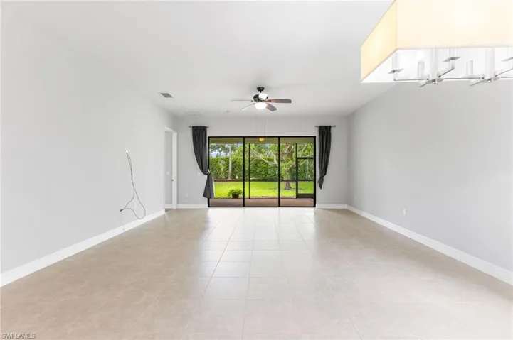 Spare room with light tile patterned flooring and ceiling fan
