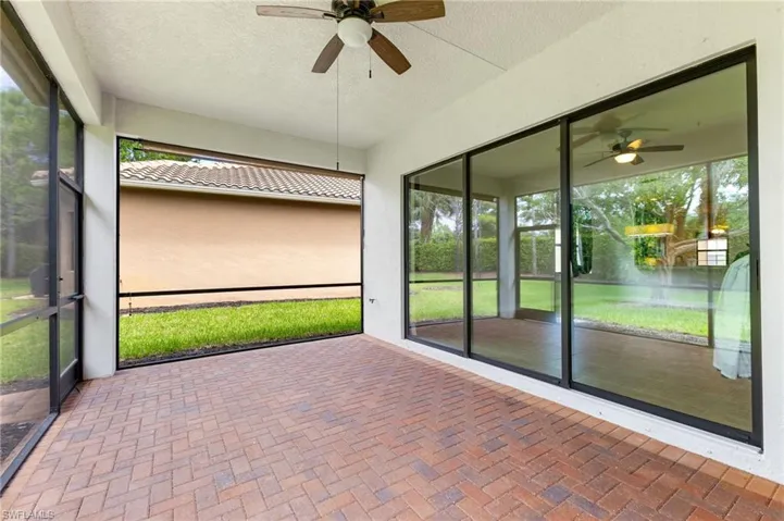 Unfurnished sunroom with ceiling fan