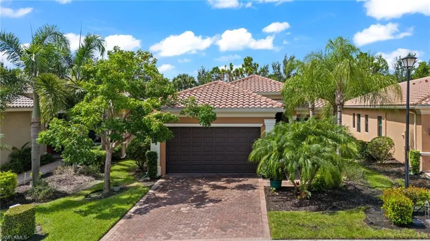 Mediterranean / spanish-style home with a garage